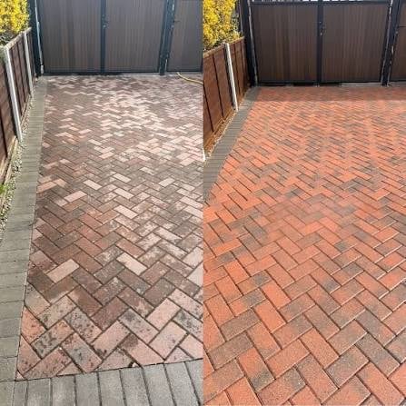 Two driveways with different colored brick patterns separated by a central divider, showing contrast between light and dark paving designs